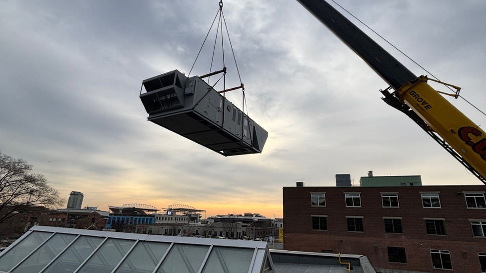 Large rooftop air-handling unit set by mobile crane on a heritage brick building (photo 6)