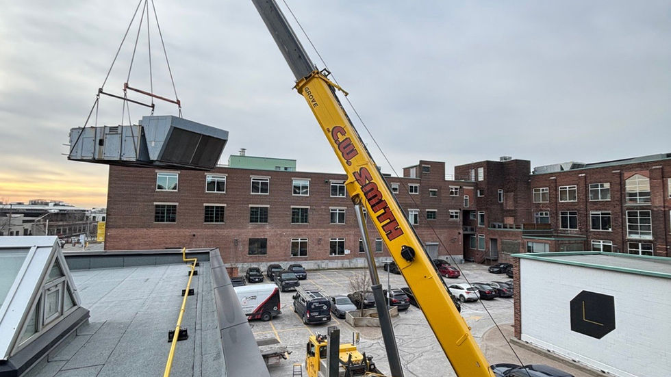 Large rooftop air-handling unit set by mobile crane on a heritage brick building (photo 4)