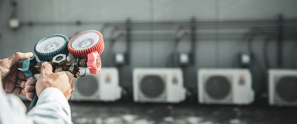 Burban Air Systems Ltd. Close up hand of engineer using measuring manifold gauge for filling industrial factory air conditioners after cleaning and checking for maintenance outdoor air compressor unit.
