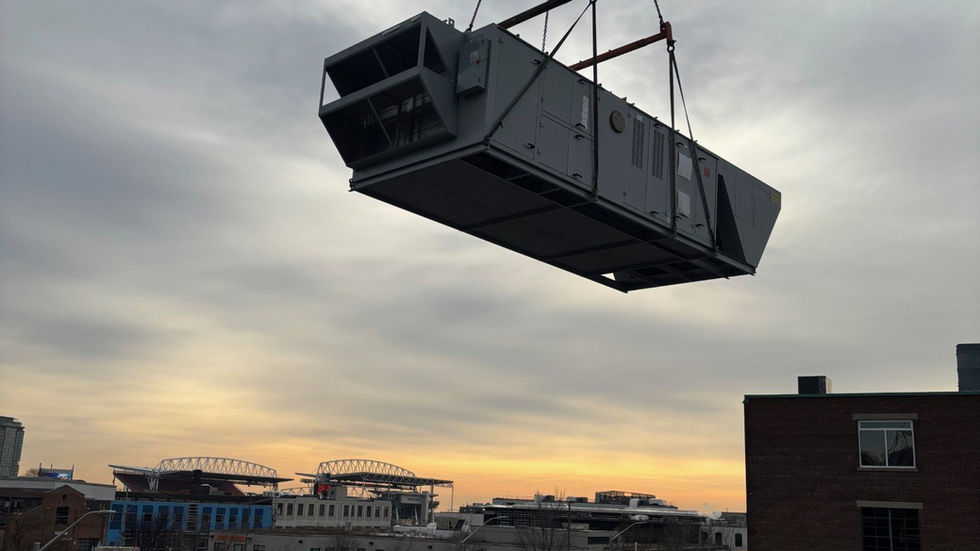 Large rooftop air-handling unit set by mobile crane on a heritage brick building (photo 1)