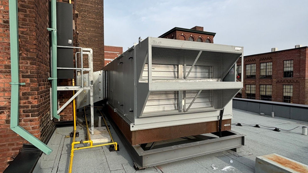 Large rooftop air-handling unit set by mobile crane on a heritage brick building (photo 10)
