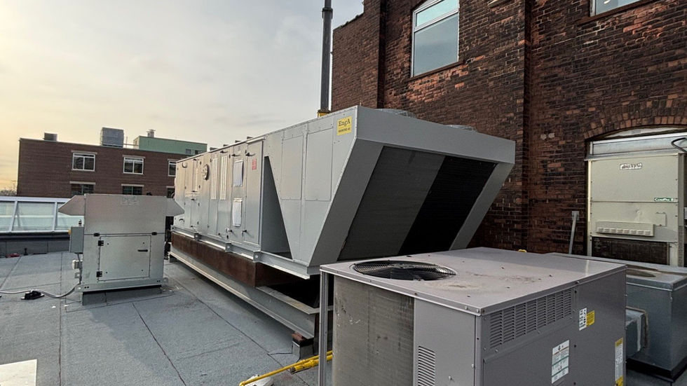 Large rooftop air-handling unit set by mobile crane on a heritage brick building (photo 9)