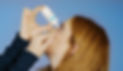 A woman applying HYLO to her eye