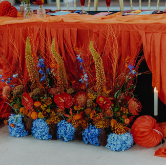 A meadow of florals with blues, reds, yellows and oranges to represent fire