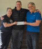 Boys & Girls Clubs Kitchen Manager, Yvette Cannon and Food Program Director, Tony Windsor, receive a $10,000 check from Bill Novick, of the Novick Corporation. The funds will support the purchase of a new heat-sealing, meal packaging machine for the Seaford self-prep kitchen.