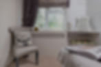 Image of a cozy corer of a hotel room in neutral colours