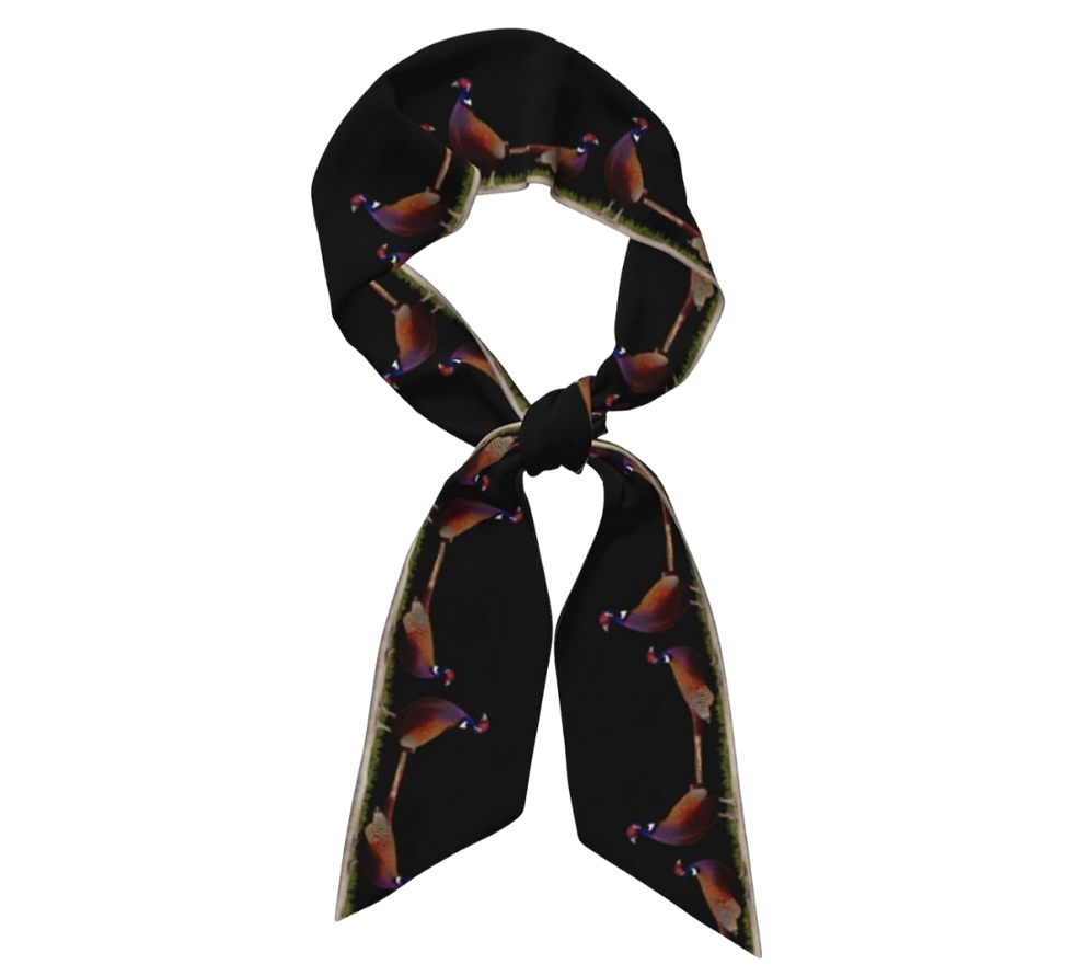 A black scarf with a colorful pheasant pattern, tied in a loop with tails hanging down. The background is plain, focusing on the design.