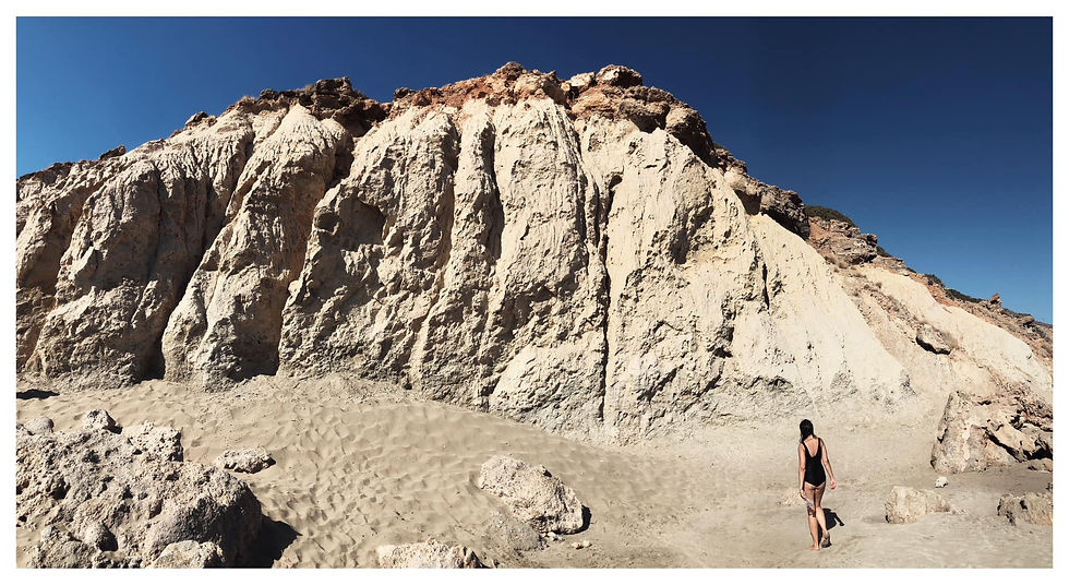 A step upon the sand — a fleeting shadow in the light, small against the vast weight of stone that seems to have slept for centuries. The rock, cracked, dry, silent — holding perhaps the memory of forgotten seas, lost winds, whispers no one remembers anymore.