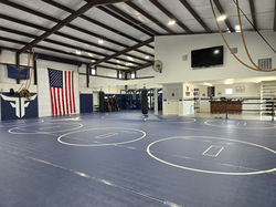 Wrestling mats viewed from the locker area entrance