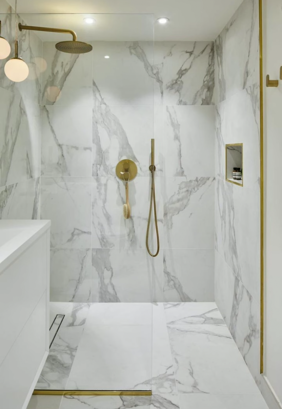 Luxury Marble Walk-In Shower with Brass Accents.png