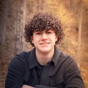 High school boy outside smiling at the camera