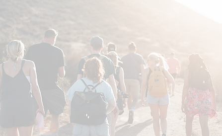 people walking on dirt road near mountai