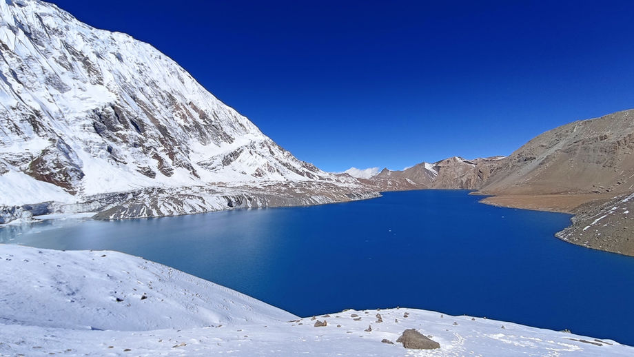 Crystal clear turquoise waters of Tilicho Lake during Annapurna Circuit trek in Nepal