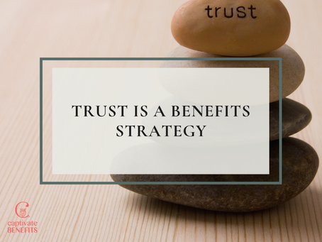 Stacked stones on wood with trust on top and the words 'Trust is a Benefits Strategy' centered; calm, minimalist benefits-themed graphic