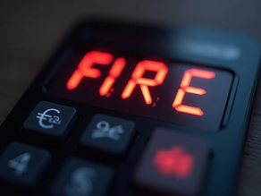 A calculator displays "FIRE" in red LED. Black buttons are visible with currency and percentage symbols. Background is blurred.