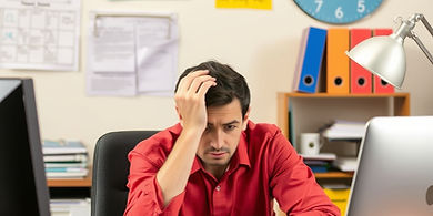 person sitting at work looking frustrated with job