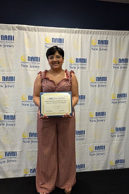 Poet, Damaris Chanza, receiving her award for a the NAMI NJ 2024 Poetry Writing Contest