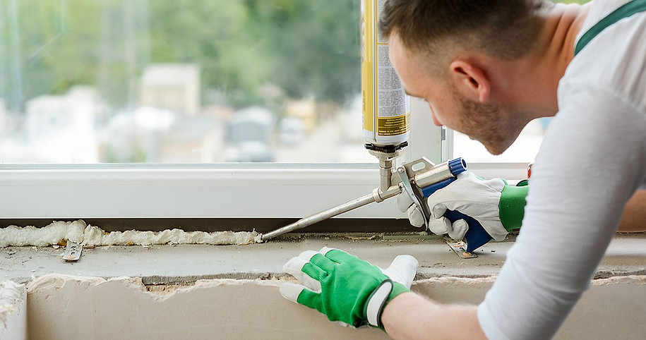 A-worker-applying-caulk-on-the-interior-of-window.jpg