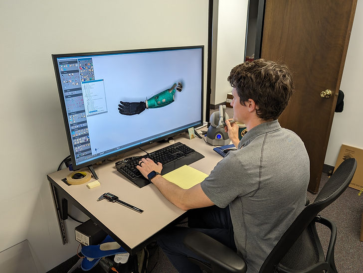 clinician using CAD software to design a prosthetic arm
