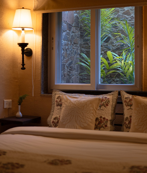 Boutique stay room near Sariska with earthy interiors and warm ambient lighting