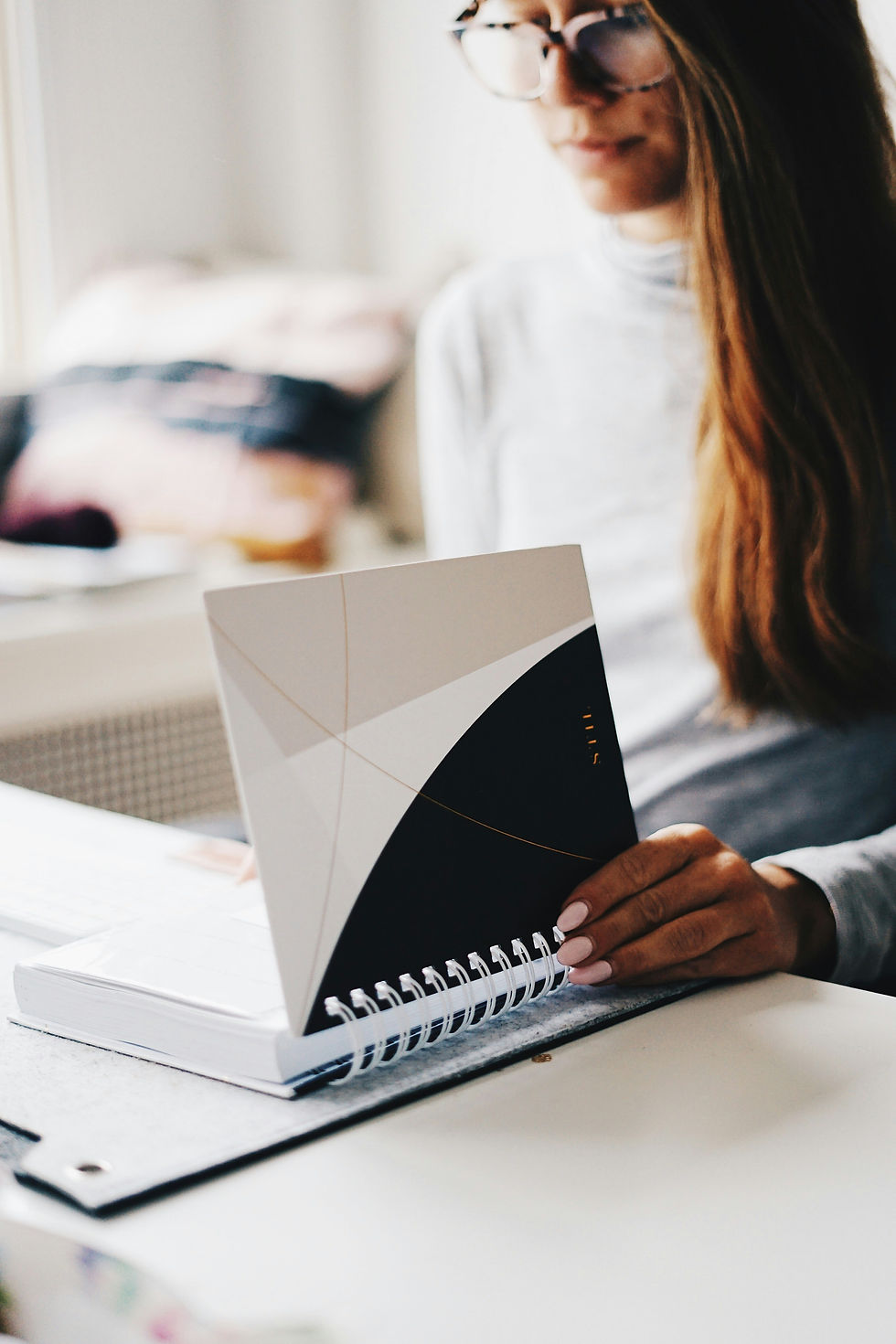 Woman thoughtfully reviewing what to do with her tax return at home