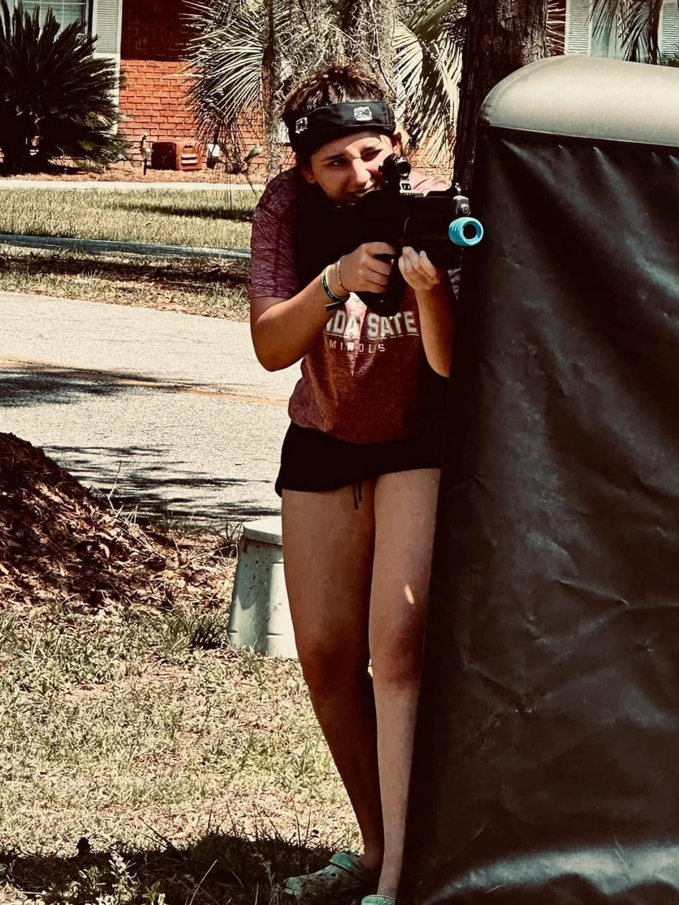 Girl aiming a laser tag gun