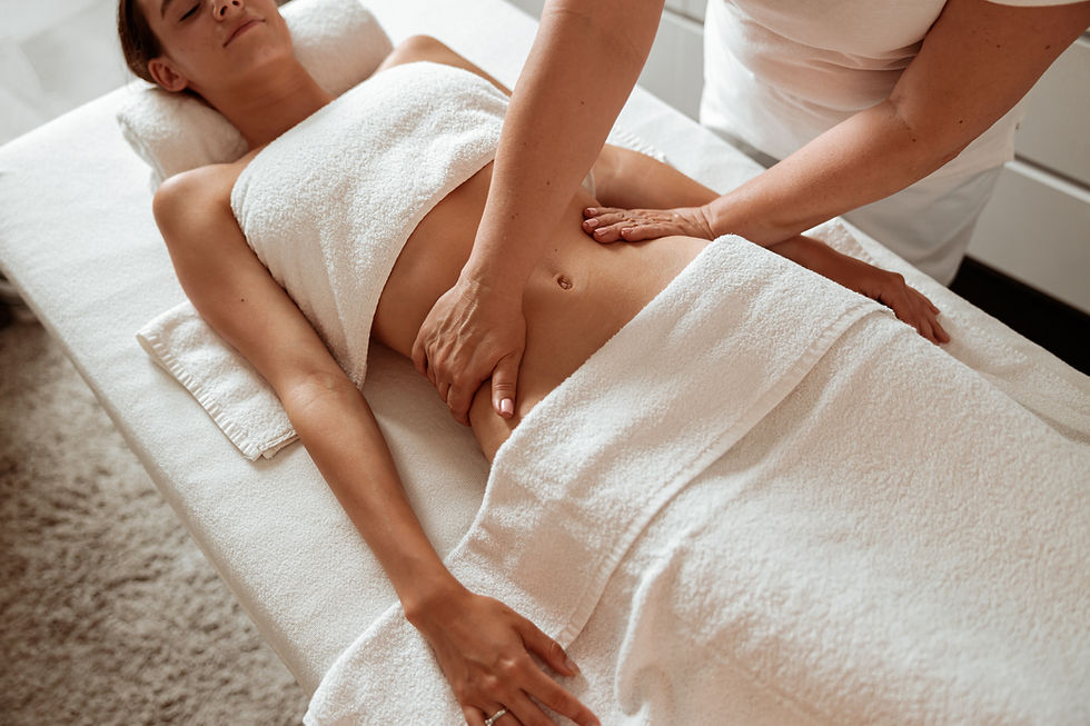 Masseuse hands massaging woman abdomen in spa salon.jpg