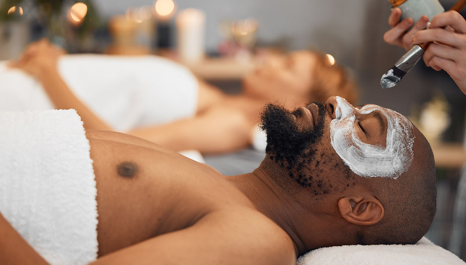 Skincare, wellness and black man getting a facial at a spa for relaxation, calm and satisf