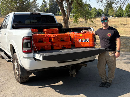white truck with orange cases with numbers on them standing next to man wearing hat and sunglasses
