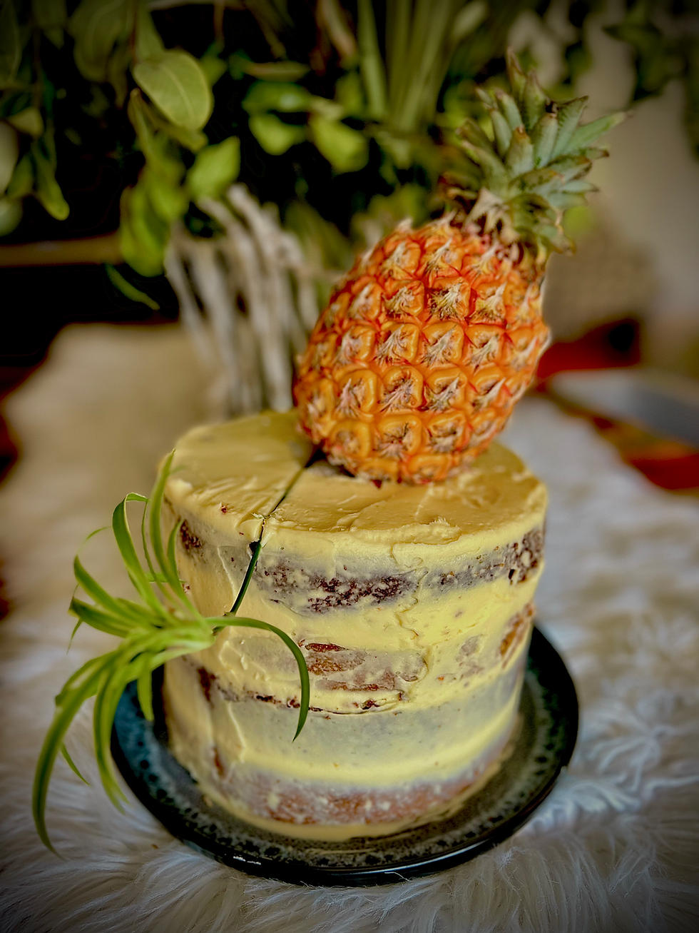 “Adventure Lifestyle Magazine Hummingbird-Carrot Fusion Cake – naked cake layered with banana and carrot cake, grenadilla pulp, cream cheese icing, and garnished with nuts and banana slices.”