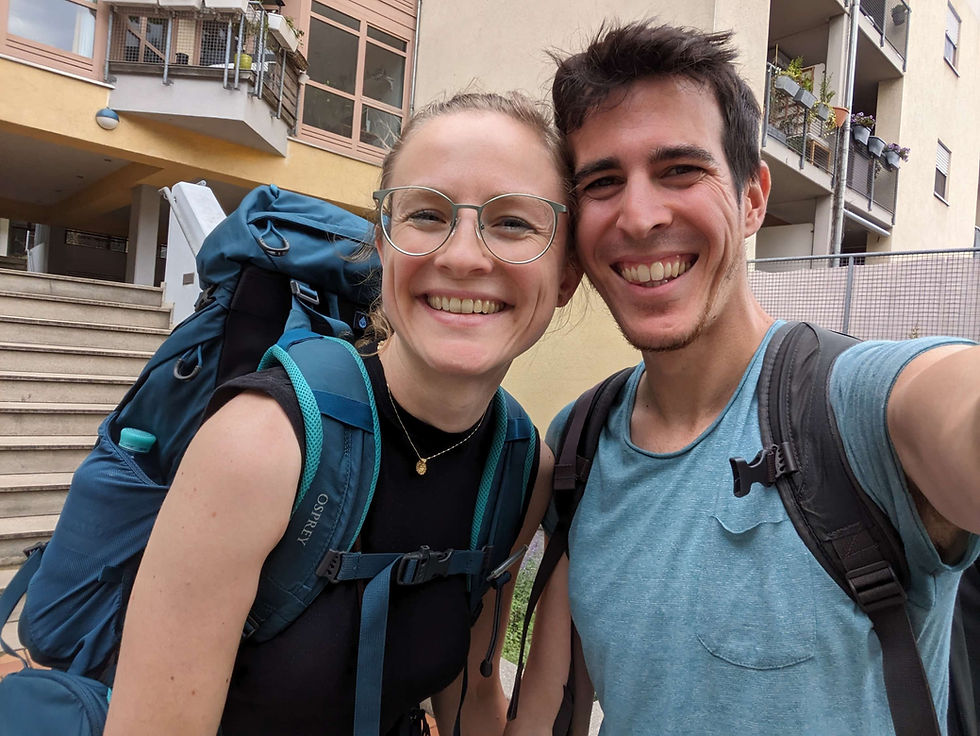 Two people (Trixi and Èric) happy to start a travel with 2 backpacks