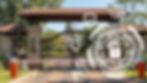 An image shows a blurred background of a secure residential or commercial gate with a boom barrier. Overlaying the image are several white line-art icons related to data security and privacy. These icons include a globe with a shield and checkmark, a shield with a checkmark, a group of people with a checkmark, a gavel, and a document. Prominently featured on the right is a large, circular, segmented icon resembling a radar or digital interface, with a padlock and Wi-Fi symbol at its center, surrounded by lines suggesting digital connections. Smaller dots and lines representing a network or data flow are scattered across the left side of the image.