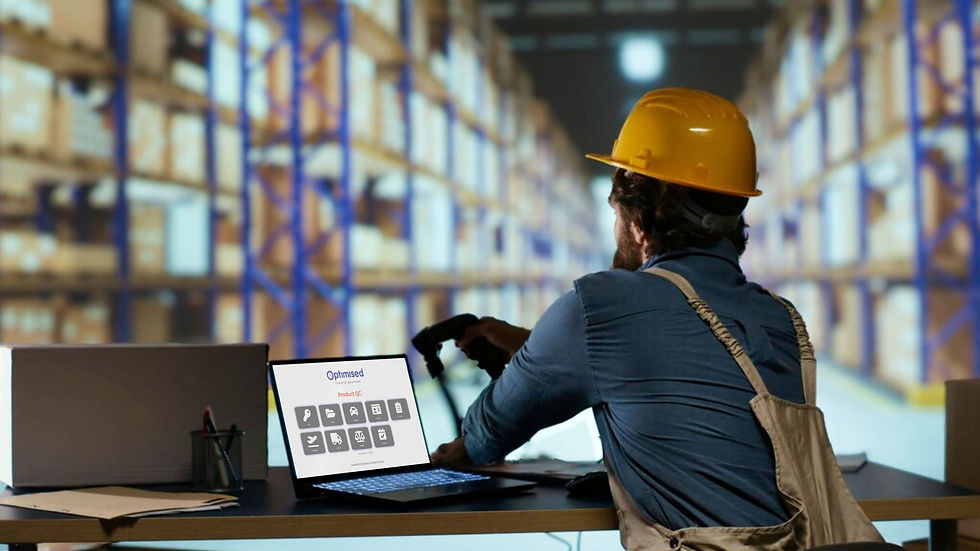 Warehouse worker using laptop to manage logistics and inventory with ATG Digital Optimised software for streamlined operations.
