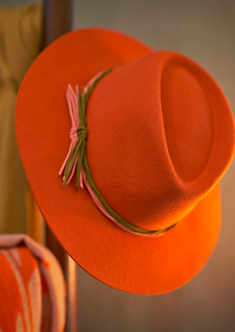 Orange felt hat with green and pink ribbon