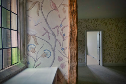Window with floral wallpaper and open doorway