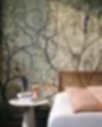 Birds and trees wallpapered bedroom