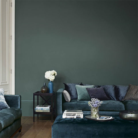 Teal living room with a sofa, two armchairs, and a coffee table