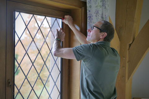 Man installing decorative window film