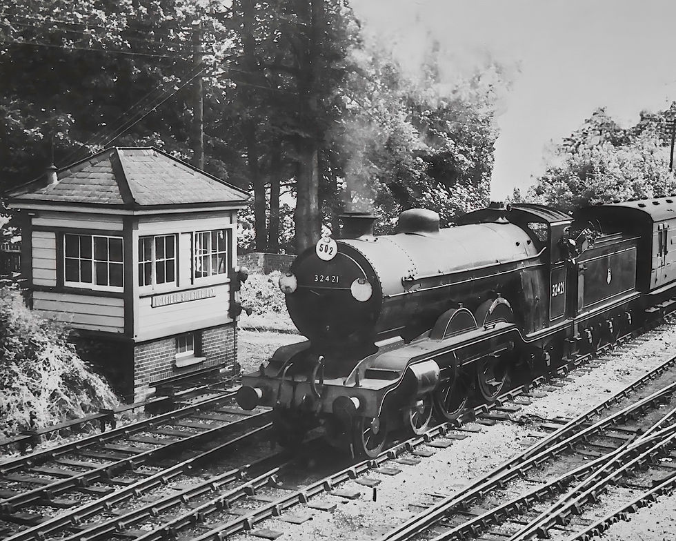 A Steam train running past Uckfield Shunting Signal Box around 1955.jpeg