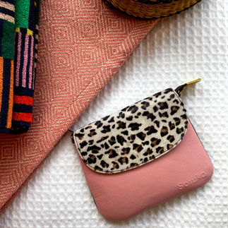 "A triptych of Soruka crossbody bags (pink/leopard, brown/zebra, blue/leopard) on flat-lay display with colourful blankets."