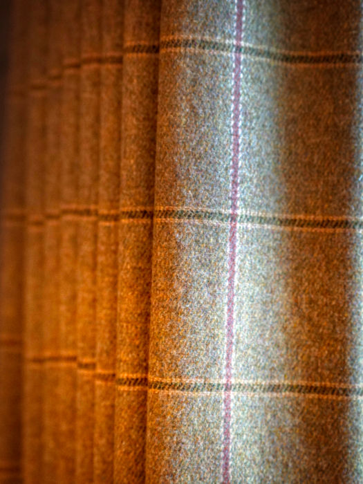 Brown plaid curtains illuminated by sunlight