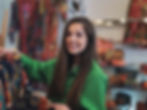 Woman in green shirt smiling and holding a colorful patterned fabric, Carvills Furnishings