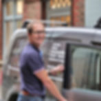 Smiling man opening a van door, Curtains Blinds Automated Blinds Curtain Poles & Cushions & Loose, Carvills Furnishings