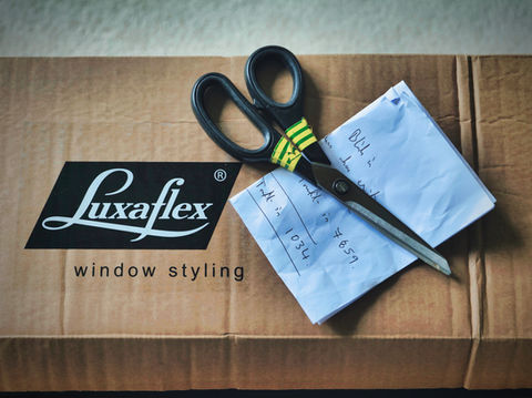 Scissors cutting Luxaflex window styling bill