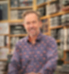 Smiling man wearing a flamingo shirt in a furniture showroom