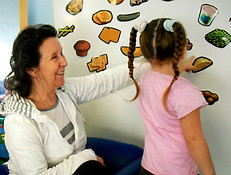 Indigenous Elder with a young girl doing a learning activity