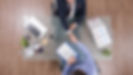 top-view-businessmen-shaking-hands-business-negotiation-startup-office.jpg