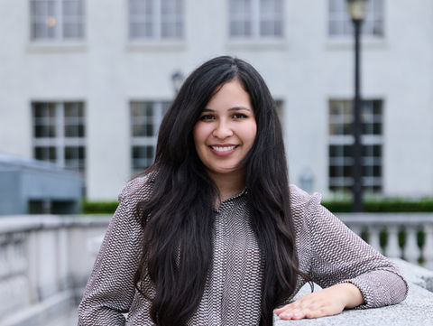 Woman wearing a grey blouse.