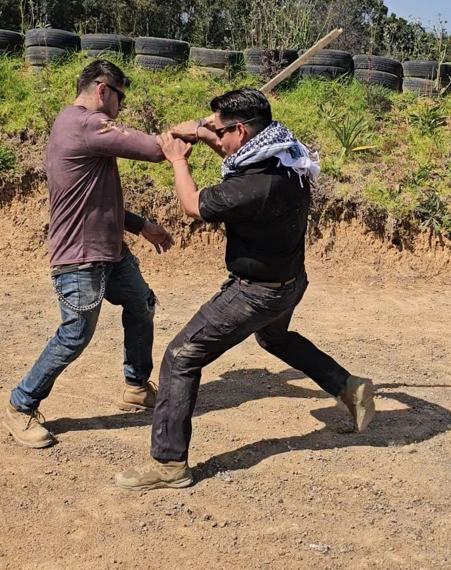 Instructor mostrando tecnica de defensa contra objetos contundente