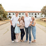 Image of a family posing together on a road